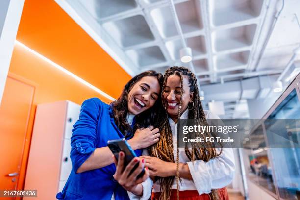 coworkers talking and using mobile phone at office - special occasions stock pictures, royalty-free photos & images