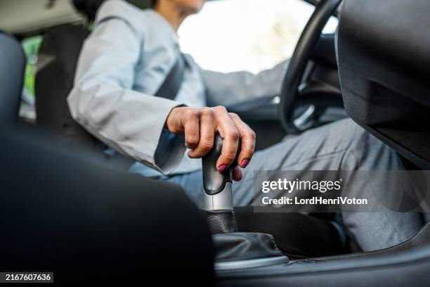 woman's hand shifting gears with a manual transmission - gearshift stock pictures, royalty-free photos & images