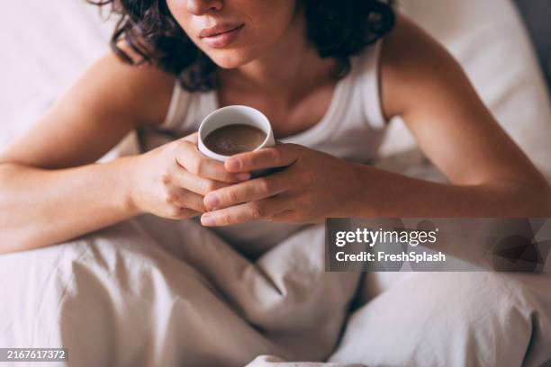 relaxed morning in bed with coffee in hand - hot drink stock pictures, royalty-free photos & images