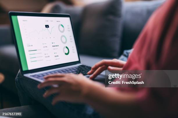 analyzing business data on laptop with graphs and charts displayed - dashboard stock pictures, royalty-free photos & images