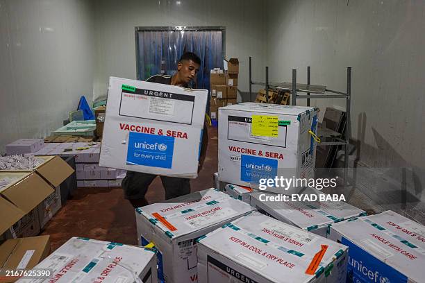 Worker unloads a shipment of polio vaccines provided with support from UNICEF to the Gaza Strip through the Karm Abu Salem crossing, also known as...