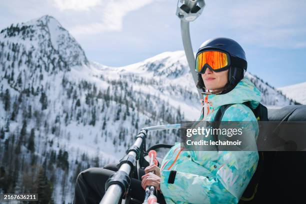 una mujer disfruta de la vista en un telesilla en los alpes franceses - alpes europeos fotografías e imágenes de stock