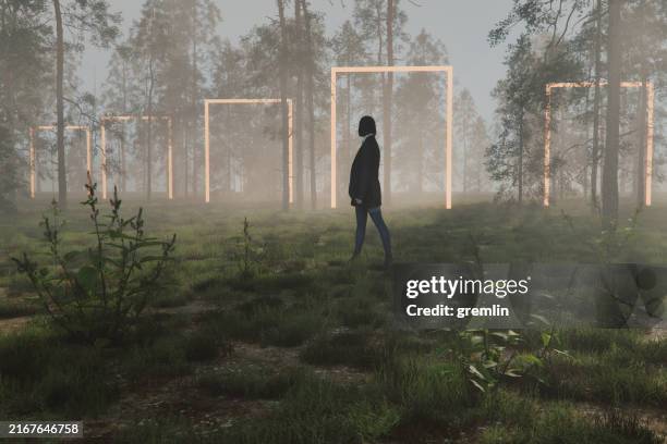 woman standing in mysterious forest - woman walking out door silhouette stock pictures, royalty-free photos & images