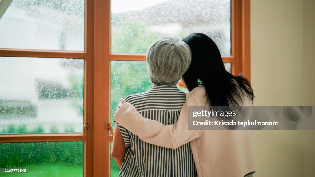 Young Asian woman and her retired mother spending time at home together.
