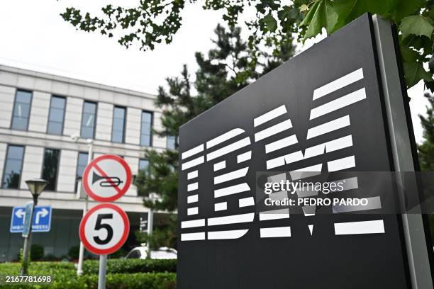The IBM logo is seen at the entrance to its China System Center building in Beijing on August 26, 2024. US computer giant IBM will eliminate over a...
