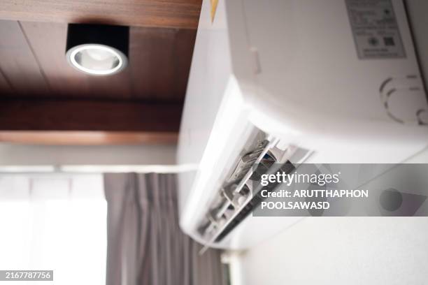 air condition and remote in bedroom - airconditioning stockfoto's en -beelden