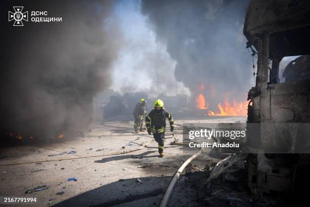 Ukrainian emergency service workers try to extinguish the fire that broke out after the Russian missile attack on Odessa, Ukraine on August 26, 2024....