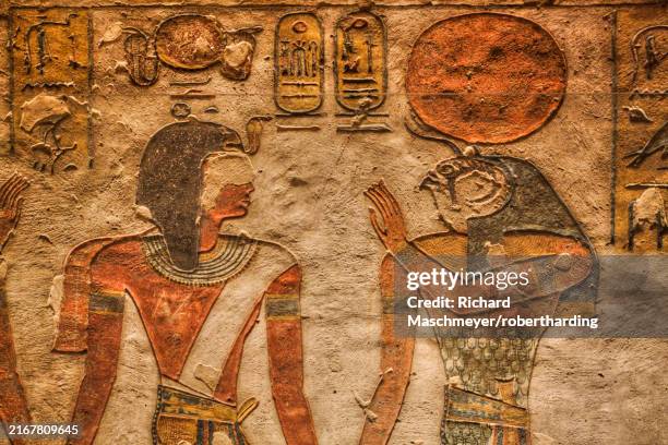 relief of pharaoh on left and egyptian god ra, tomb of rameses iii, kv11, valley of the kings, ancient thebes, unesco world heritage site, luxor, egypt, north africa, africa - horus fotografías e imágenes de stock