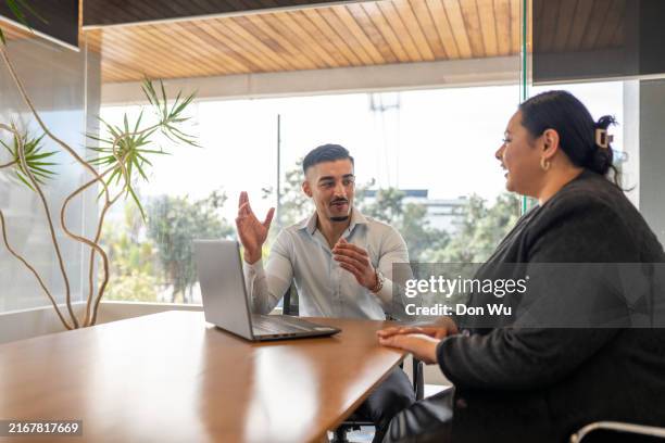 young banker giving female client financial advice - financial advisor stock pictures, royalty-free photos & images