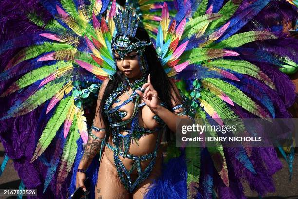 Performer in costume takes part in the main parade of the Notting Hill Carnival in west London on August 26, 2024.