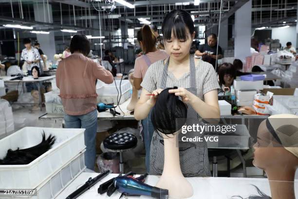 Employees make wigs at the production workshop of an e-commerce industrial park on August 21, 2024 in Xuchang, Henan Province of China.