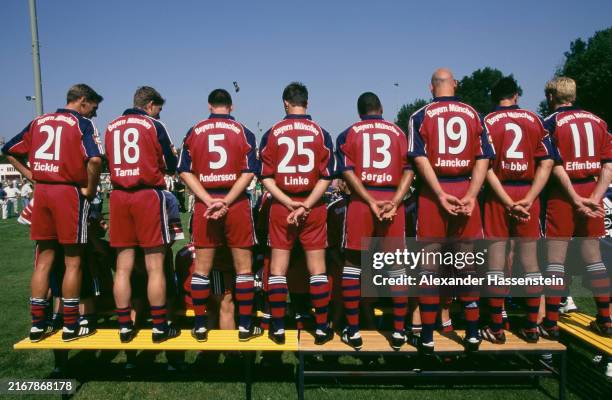 Rear view of Bayern Munich teammates , some with their hands behind their back, as they pose for a group portrait ahead of the 1999/2000 Bundesliga...