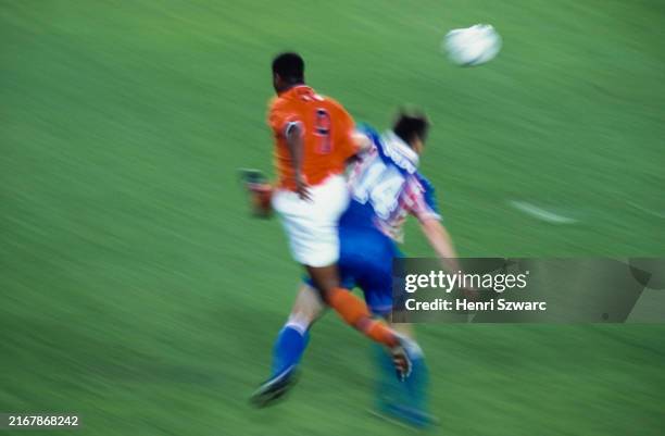 Dutch footballer Patrick Kluivert challenges Croatian footballer Zvonimir Soldo for possession during the 1998 FIFA World Cup Third-Place Play-Off...