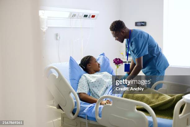close-up of a nurse measuring blood pressure of his patient - male nurse stock pictures, royalty-free photos & images