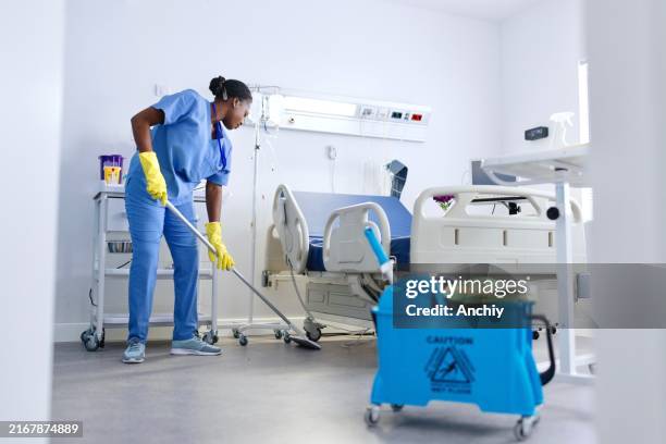 a dedicated staff member cleans the floor of a hospital room - desinficera bildbanksfoton och bilder