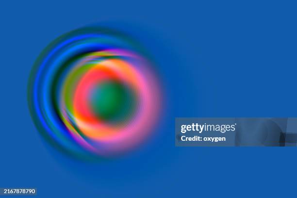 abstract colorful swirl blured circle on blue background. a dynamic abstract swirl featuring vibrant colors like green, red, and purple, set against a deep blue background. - optical illusion stock pictures, royalty-free photos & images