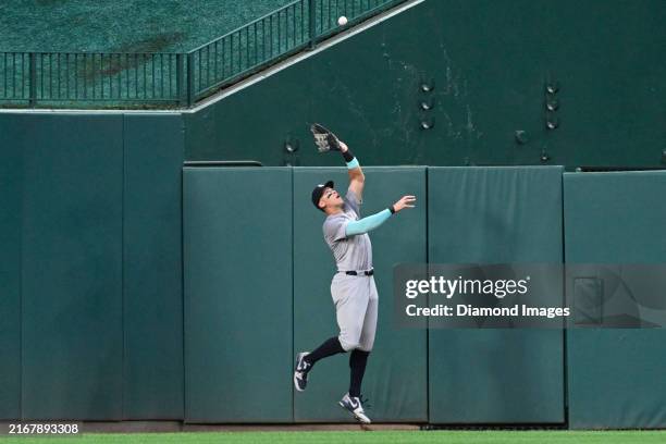 Aaron Judge of the New York Yankees leaps up against the outfield wall to catch a fly ball hit by Jose Tena of the Washington Nationals during the...
