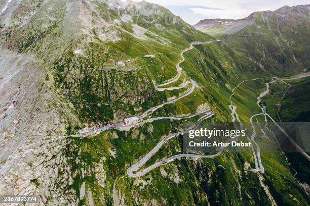 aerial view of the curvy furka pass mountain road in switzerland - mountain road stock pictures, royalty-free photos & images