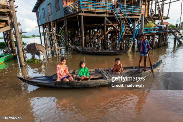 cambodian kids rowing a boat, siem reap, cambodia - provinsen siem reap bildbanksfoton och bilder
