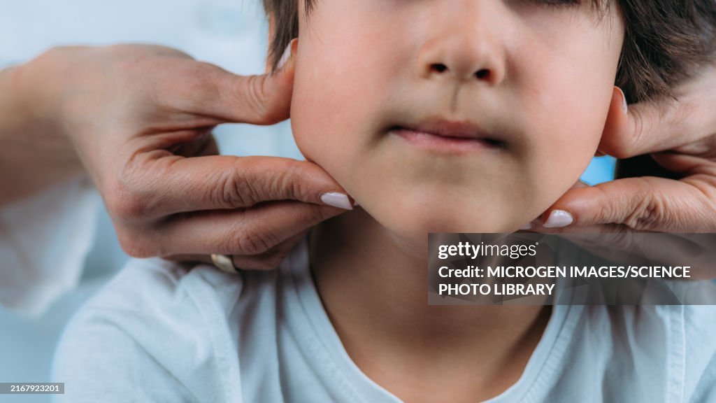 Paediatric endocrinologist examining boy