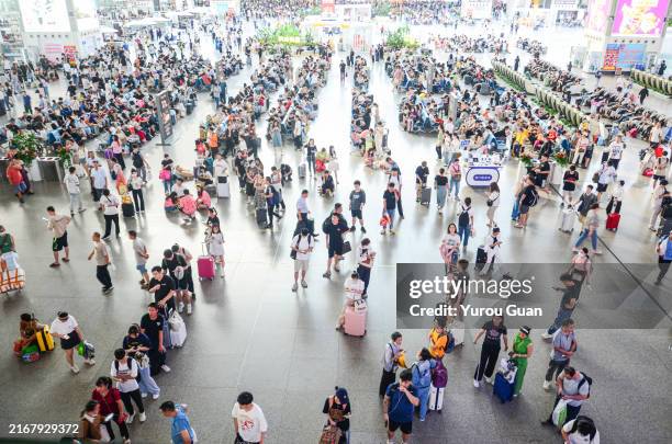 passengers waiting inside guangzhou south railway station. - guangzhou stock pictures, royalty-free photos & images