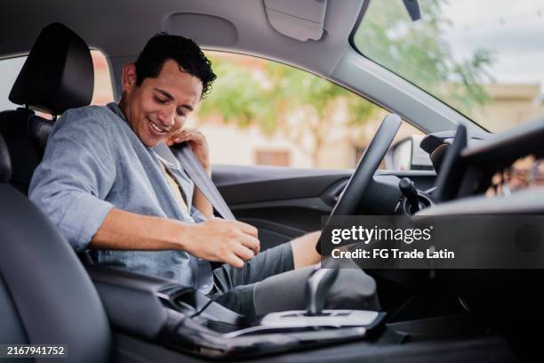 mid adult man putting the seat in the car - fastening stock pictures, royalty-free photos & images