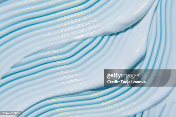 white smears of face cream moisturizer texture on light blue. lotion for face or body. skin care. - shampoo stockfoto's en -beelden