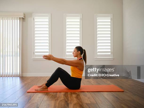 young woman exercising in a home - russian ethnicity stock pictures, royalty-free photos & images