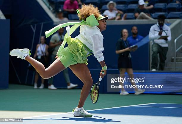 Japan's Naomi Osaka warms up before her women's singles first round match against Latvia's Jelena Ostapenko on day two of the US Open tennis...