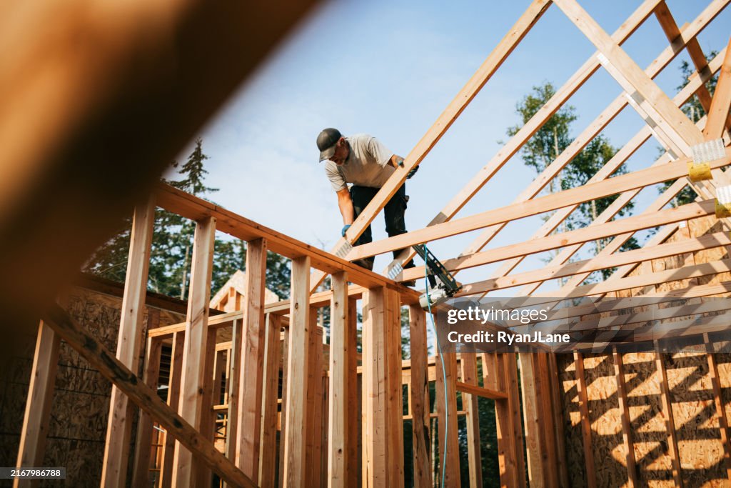 Construction Crew Putting Up Framing of New Home