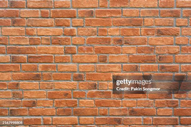 full frame photo of a red brick wall texture as background. - ziegelmauer stock-fotos und bilder