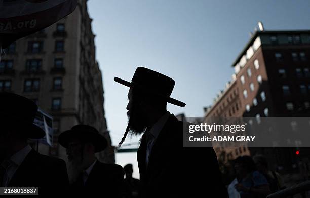 Members of the Haredi Jewish group Neturei Karta counter protest as people attend a demonstration, organised by the group End Jew Hatred outside of...