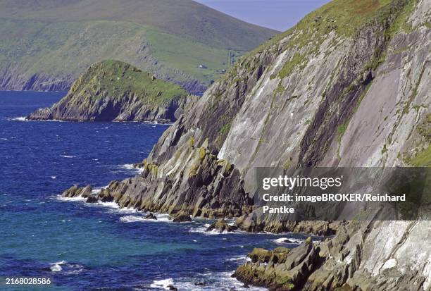 breathtaking cliff landscape, coloured in green and grey, lined with deep blue sea and green hills, tourism, slea head drive, dingle, ireland, europe - slea head stock pictures, royalty-free photos & images
