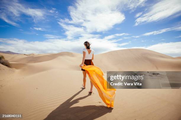 portrait of beautiful brunette woman walking in maspalomas dunes at summertime - maspalomas imagens e fotografias de stock