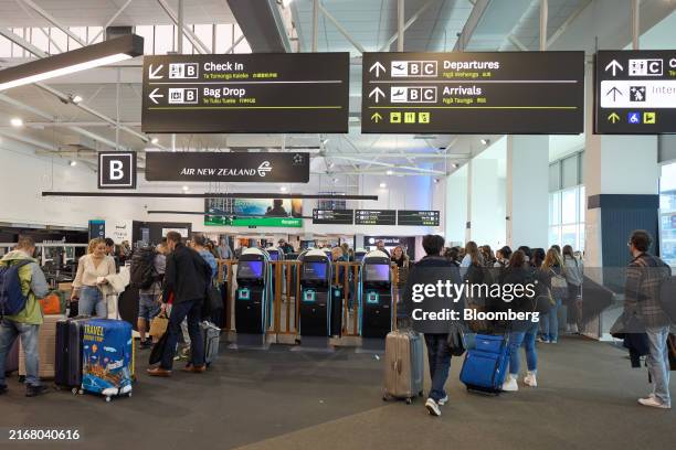 Travelers in front of the Air New Zealand Ltd. Check-in counters at Auckland Airport on Wednesday, Aug. 28, 2024. Air New Zealand is scheduled to...