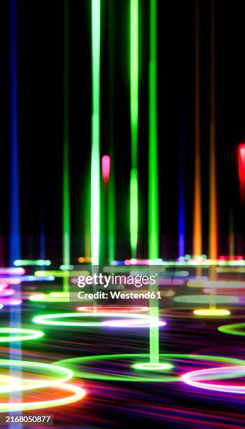 3d render of falling multi colored laser lights effect against black background - led screen stock illustrations