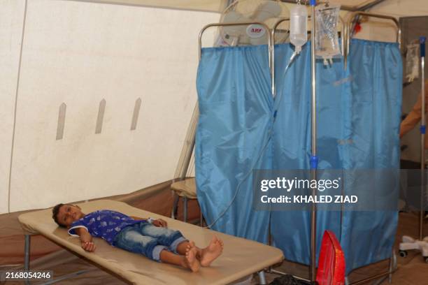 Cholera patients receive treatment at a clinic in the Hays region, south of Yemen's Hodeidah Governorate on August 21, 2024. Clinics in western Yemen...