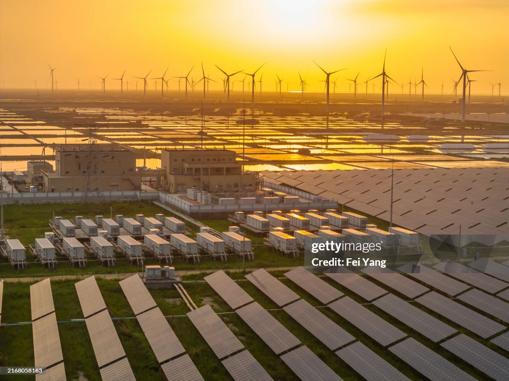 Energy storage power station, solar power station and wind power station at sunset