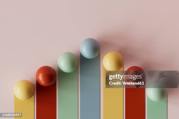 3d render of multi colored graph bars with spheres against pink background - 3d sphere stock illustrations