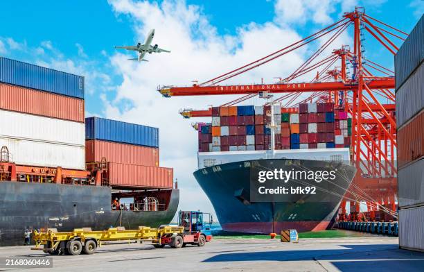 cargo airplane flying above container ship. - air cargo stock pictures, royalty-free photos & images