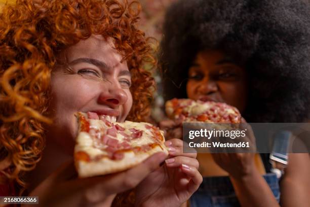 multiracial roommates eating slice of pizza - eating pizza stock pictures, royalty-free photos & images