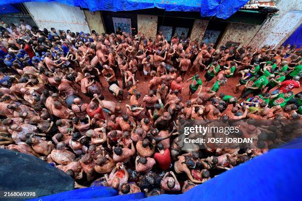 Revellers take part in the "Tomatina" annual food battle in the Spanish eastern town of Bunol, on August 28, 2024. Thousands of people gather in...