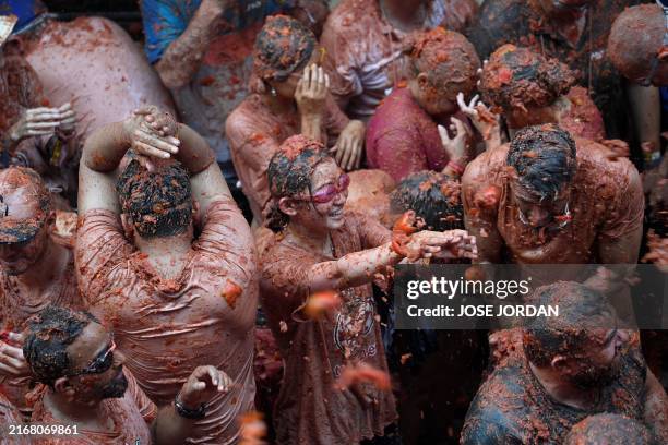 Revellers take part in the "Tomatina" annual food battle in the Spanish eastern town of Bunol, on August 28, 2024. Thousands of people gather in...
