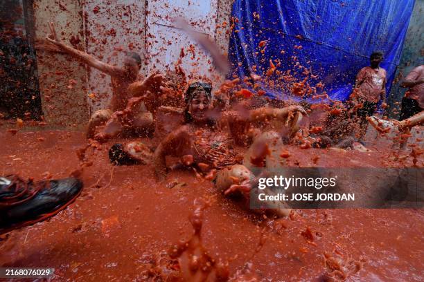 Revellers take part in the "Tomatina" annual food battle in the Spanish eastern town of Bunol, on August 28, 2024. Thousands of people gather in...