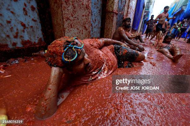 Revellers take part in the "Tomatina" annual food battle in the Spanish eastern town of Bunol, on August 28, 2024. Thousands of people gather in...