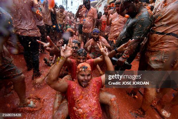 Revellers take part in the "Tomatina" annual food battle in the Spanish eastern town of Bunol, on August 28, 2024. Thousands of people gather in...