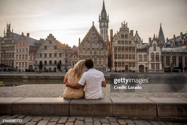 a mixed race couple enjoying a premium travel sightseeing walk in ghent, belgium - gent stockfoto's en -beelden