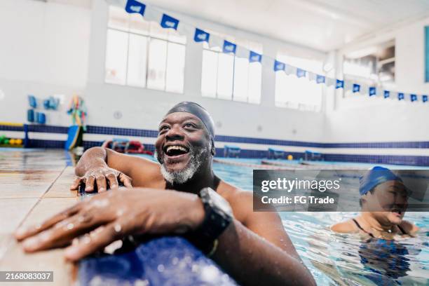 mature man talking with instructor at swimming pool - aerobics stock pictures, royalty-free photos & images