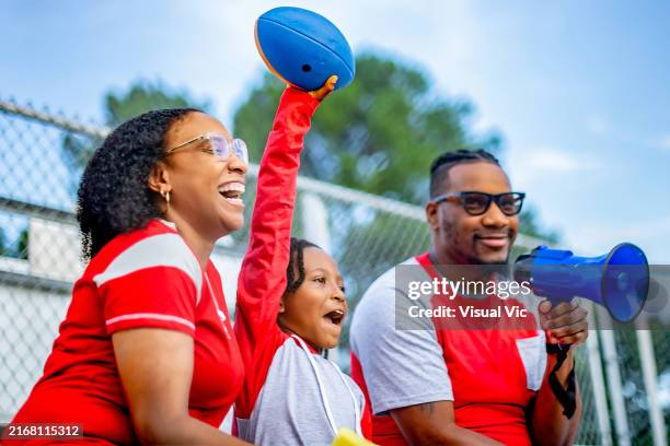 sports fans at the game cheering together - homecoming stock pictures, royalty-free photos & images