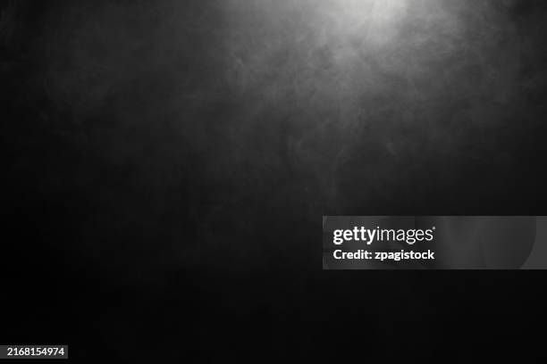 gray monochrome smoke or fog against black background - smoking stock pictures, royalty-free photos & images